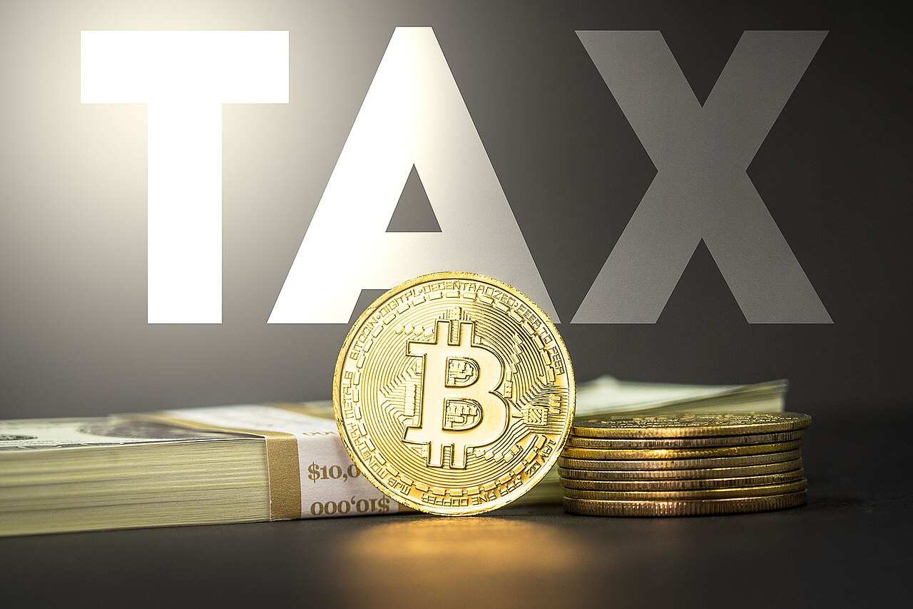 Cryptocurrency tax concept image featuring a Bitcoin crypto medallion alongside 