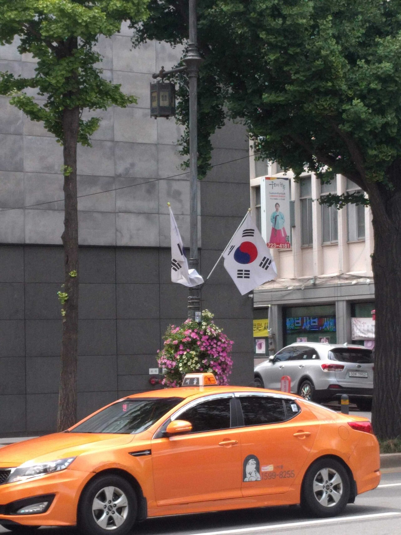 This is an image of a yellow taxi cab in downtown Seoul, South Korea.
